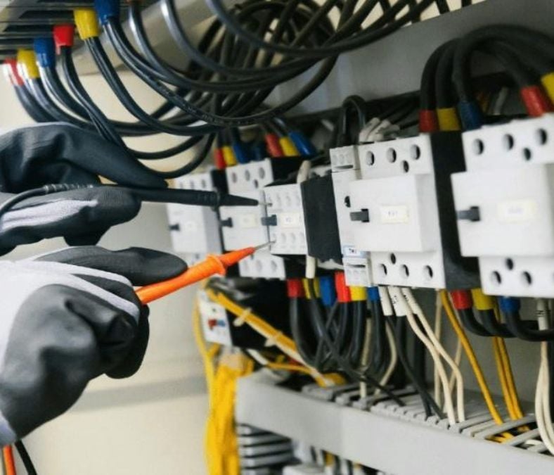 A technician examining and repairing cables during air conditioning service in Smyrna, TN