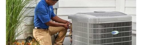 HVAC technician inspecting an outdoor air conditioner for air conditioner repair in MT Juliet TN