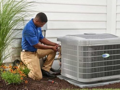 HVAC technician inspecting an outdoor air conditioner for air conditioner repair in MT Juliet TN