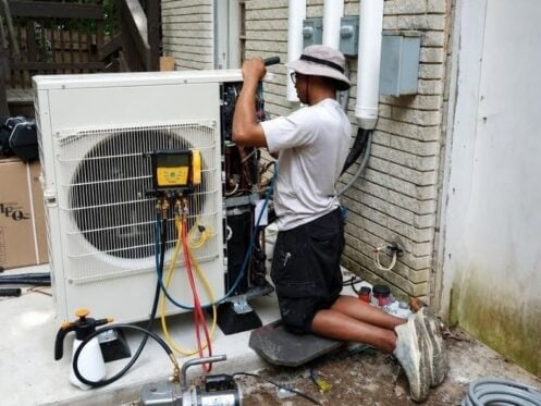 HVAC technician performing air conditioning repair in Murfreesboro TN on a residential AC system.