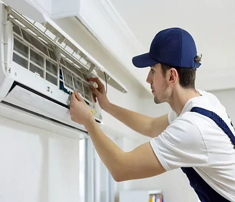 Technician inspecting a residential AC for signs of air conditioner repair in MT. Juliet, TN