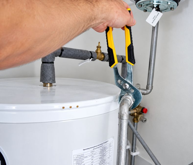 Technician inspecting a water heater for repair